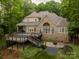 Aerial view of a home highlighting the large deck, stone patio, and lush landscaping at 9013 Yellow Pine Ct, Waxhaw, NC 28173