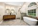 Stylish bathroom featuring a soaking tub, walk-in shower, and a double vanity sink at 9013 Yellow Pine Ct, Waxhaw, NC 28173