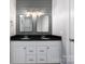 Bathroom boasts double vanity, granite countertop, white cabinets, and modern lighting at 9013 Yellow Pine Ct, Waxhaw, NC 28173