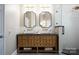 Bathroom featuring a double vanity sink, walk-in shower with a glass door, and modern finishes at 9013 Yellow Pine Ct, Waxhaw, NC 28173