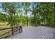 Expansive deck overlooking a serene backyard with lush trees and a distant pond at 9013 Yellow Pine Ct, Waxhaw, NC 28173