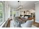 Open-concept dining room features hardwood floors, large windows, and a view into the kitchen at 9013 Yellow Pine Ct, Waxhaw, NC 28173