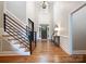 Grand foyer with hardwood floors, tall ceilings, and a striking staircase at 9013 Yellow Pine Ct, Waxhaw, NC 28173