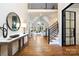 Welcoming foyer featuring hardwood floors, a staircase, and an open view to the living room at 9013 Yellow Pine Ct, Waxhaw, NC 28173