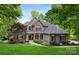 Beautiful two story home with a brick facade, manicured lawn, mature trees, and charming walkway at 9013 Yellow Pine Ct, Waxhaw, NC 28173