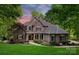 Elegant brick home with well-manicured lawn, walkway, and inviting covered front porch at 9013 Yellow Pine Ct, Waxhaw, NC 28173
