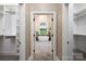 Hallway view of a bathroom with a soaking tub and walk-in shower between two walk-in closets at 9013 Yellow Pine Ct, Waxhaw, NC 28173