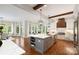 Open concept kitchen with a center island, white cabinets, hardwood floors, and an eat-in area at 9013 Yellow Pine Ct, Waxhaw, NC 28173