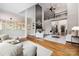 Inviting living room featuring hardwood floors, a fireplace, comfortable seating, and a stylish decor at 9013 Yellow Pine Ct, Waxhaw, NC 28173