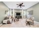 Comfortable living room features neutral walls, carpet, and large windows with white curtains at 9013 Yellow Pine Ct, Waxhaw, NC 28173
