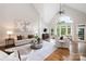 Bright living room with vaulted ceilings, large windows, hardwood floors, and cozy seating area at 9013 Yellow Pine Ct, Waxhaw, NC 28173