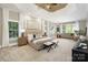 Spacious main bedroom boasts carpeted floors, a tray ceiling, and a sitting area with natural lighting at 9013 Yellow Pine Ct, Waxhaw, NC 28173