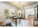 Well-lit office with dark wood floors, a modern light fixture, and glass panel doors at 9013 Yellow Pine Ct, Waxhaw, NC 28173