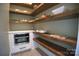 Walk-in pantry with custom shelving, a microwave, and stylish tile flooring at 9013 Yellow Pine Ct, Waxhaw, NC 28173