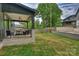 Backyard patio with iron railing and ceiling fan overlooking a grassy lawn at 910 Everett Pl, Charlotte, NC 28205