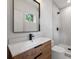 Modern bathroom showcasing wood vanity, quartz countertop, and walk-in shower with elegant finishes at 910 Everett Pl, Charlotte, NC 28205