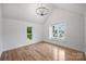 Airy bedroom with high ceilings and hardwood floors, complemented by abundant natural light at 910 Everett Pl, Charlotte, NC 28205