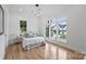 Bright and spacious bedroom with hardwood floors, large windows, and modern lighting at 910 Everett Pl, Charlotte, NC 28205