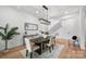Elegant dining room featuring modern chandelier, console table with decor, and open access to the staircase at 910 Everett Pl, Charlotte, NC 28205