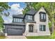 Stunning two-story home featuring a brick and wood exterior, dark trim, and attached two-car garage at 910 Everett Pl, Charlotte, NC 28205