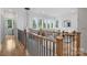Upstairs hallway with wood floors, and windows showing the bright exterior at 910 Everett Pl, Charlotte, NC 28205