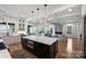 Gourmet kitchen open to the living room features a large island, white cabinets, and stainless steel appliances at 910 Everett Pl, Charlotte, NC 28205