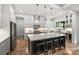 Modern kitchen with white cabinets, large island, stainless steel appliances, and stylish pendant lighting at 910 Everett Pl, Charlotte, NC 28205