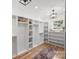 Well-organized walk-in closet boasts ample shelving and storage space with natural light at 910 Everett Pl, Charlotte, NC 28205