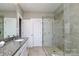 Modern bathroom featuring a granite countertop, white cabinets, and glass-enclosed shower at 926 Steel House Blvd, Charlotte, NC 28205
