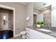 Bathroom with granite countertop, white cabinets, and a mirror with view to the exterior at 926 Steel House Blvd, Charlotte, NC 28205