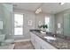 Bathroom with granite vanity, glass enclosed shower and large mirror at 926 Steel House Blvd, Charlotte, NC 28205
