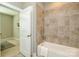 Bathroom with tiled bath and shower combination and neutral color palette at 926 Steel House Blvd, Charlotte, NC 28205