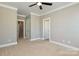 Neutral carpeted bedroom with two doors, ceiling fan, and ample natural light at 926 Steel House Blvd, Charlotte, NC 28205