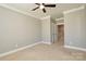 Bedroom with neutral walls, carpeted flooring, ceiling fan, and access to another room at 926 Steel House Blvd, Charlotte, NC 28205