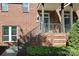 Brick townhouse exterior features a stoop with metal railings and manicured landscaping at 926 Steel House Blvd, Charlotte, NC 28205