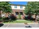 Brick townhome with front lawn, bushes, and parking on a sunny day at 926 Steel House Blvd, Charlotte, NC 28205
