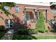 Inviting brick townhome entrance with manicured landscaping, covered entryway, and iron railings at 926 Steel House Blvd, Charlotte, NC 28205