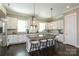 Bright, modern kitchen features a large island with seating, granite countertops, and stainless steel appliances at 926 Steel House Blvd, Charlotte, NC 28205