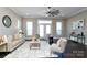 Bright living room featuring a ceiling fan, neutral decor, and access to the outdoors at 926 Steel House Blvd, Charlotte, NC 28205