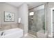 Bathroom showcasing a soaking tub and glass-enclosed shower with modern fixtures and tile work at 926 Steel House Blvd, Charlotte, NC 28205