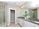 Main bathroom featuring a double vanity with granite countertops, a separate tub, and glass shower at 926 Steel House Blvd, Charlotte, NC 28205