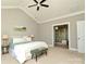 Main bedroom with attached bath with tile shower. Also shows ceiling fan, neutral paint and light carpet at 926 Steel House Blvd, Charlotte, NC 28205