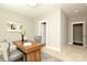 Neutral-toned office with wooden desk, two chairs, and a doorway to an adjacent room at 926 Steel House Blvd, Charlotte, NC 28205