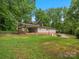 Backyard view showcasing a house, carport, and lush green lawn at 981 Meadowlark Dr, Rock Hill, SC 29732