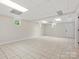 Spacious basement area with tile flooring, natural light, and a white door at 981 Meadowlark Dr, Rock Hill, SC 29732