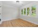 Bright bedroom with hardwood floors, large windows offering a view of the outdoors, and fresh paint at 981 Meadowlark Dr, Rock Hill, SC 29732