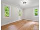 Bright bedroom with refinished hardwood floors and three windows at 981 Meadowlark Dr, Rock Hill, SC 29732
