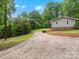 Gravel driveway that leads to a charming house surrounded by lush landscaping at 981 Meadowlark Dr, Rock Hill, SC 29732
