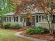 Inviting home exterior with brick stairs, black railings, and lush landscaping for added curb appeal at 981 Meadowlark Dr, Rock Hill, SC 29732