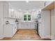 Contemporary kitchen with white cabinets, stainless appliances, and an open layout, with a view of the backyard at 981 Meadowlark Dr, Rock Hill, SC 29732